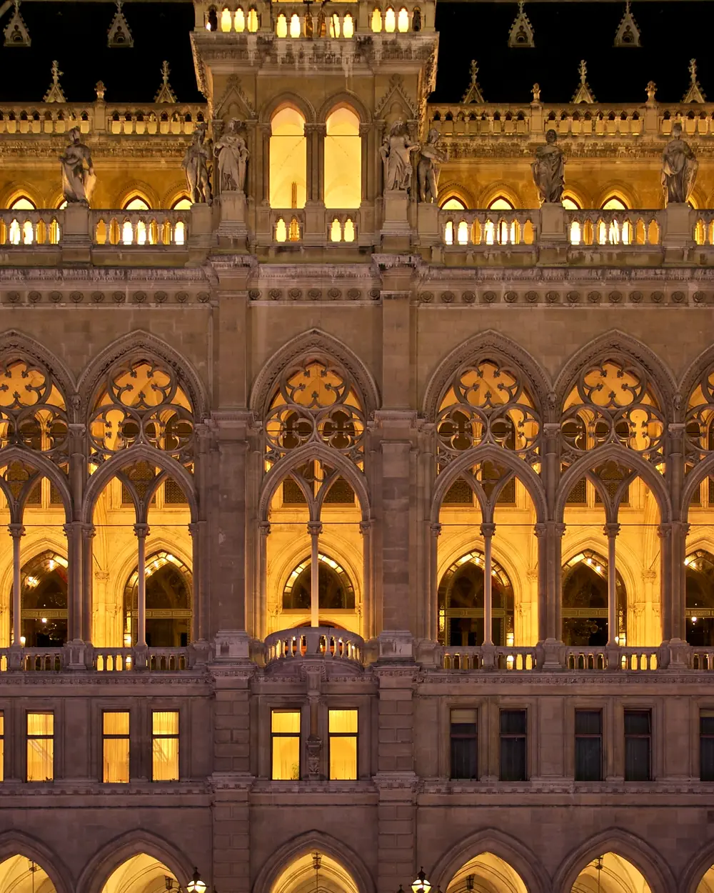 The facade of Vienna's City Hall, lit in the evening
