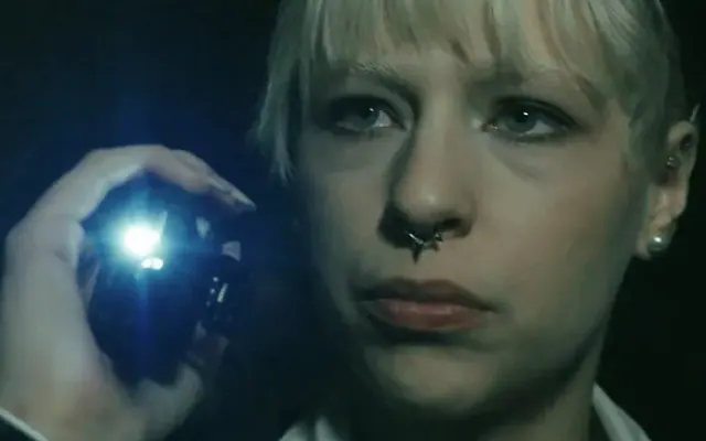 Agent examining a clue by torchlight