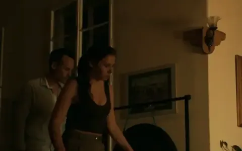 Two agents sneaking through a room at night
