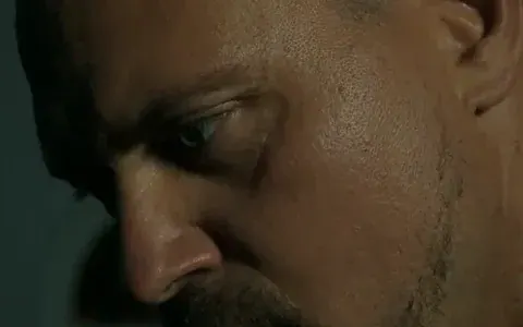 Tense look of an agent in the half-light