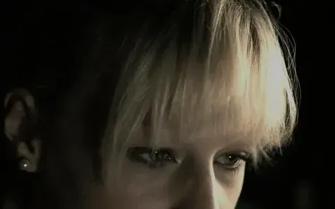 Blonde agent with an enigmatic look in the half-light
