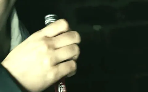 Hand holding a vial containing a sample