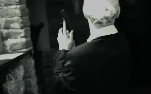 Agent in a dark suit in a basement room