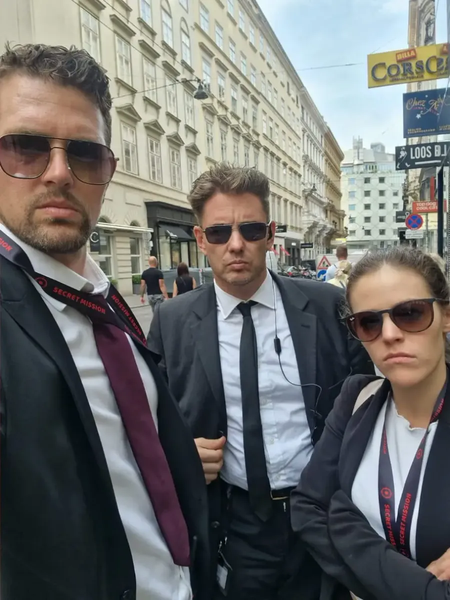 Three agents with Secret Mission lanyards on a street in Vienna’s old town