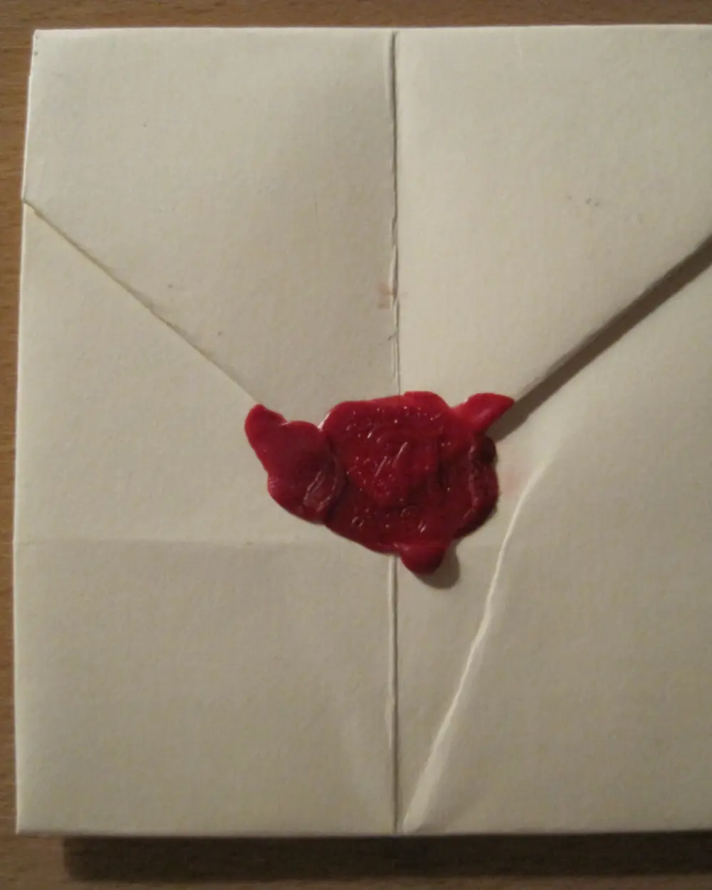 A folded letter closed with a red wax seal